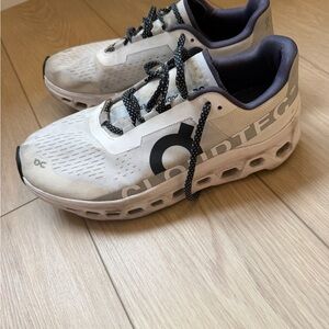 On Running Men’s Cloudmonster Cream and Black Sneakers